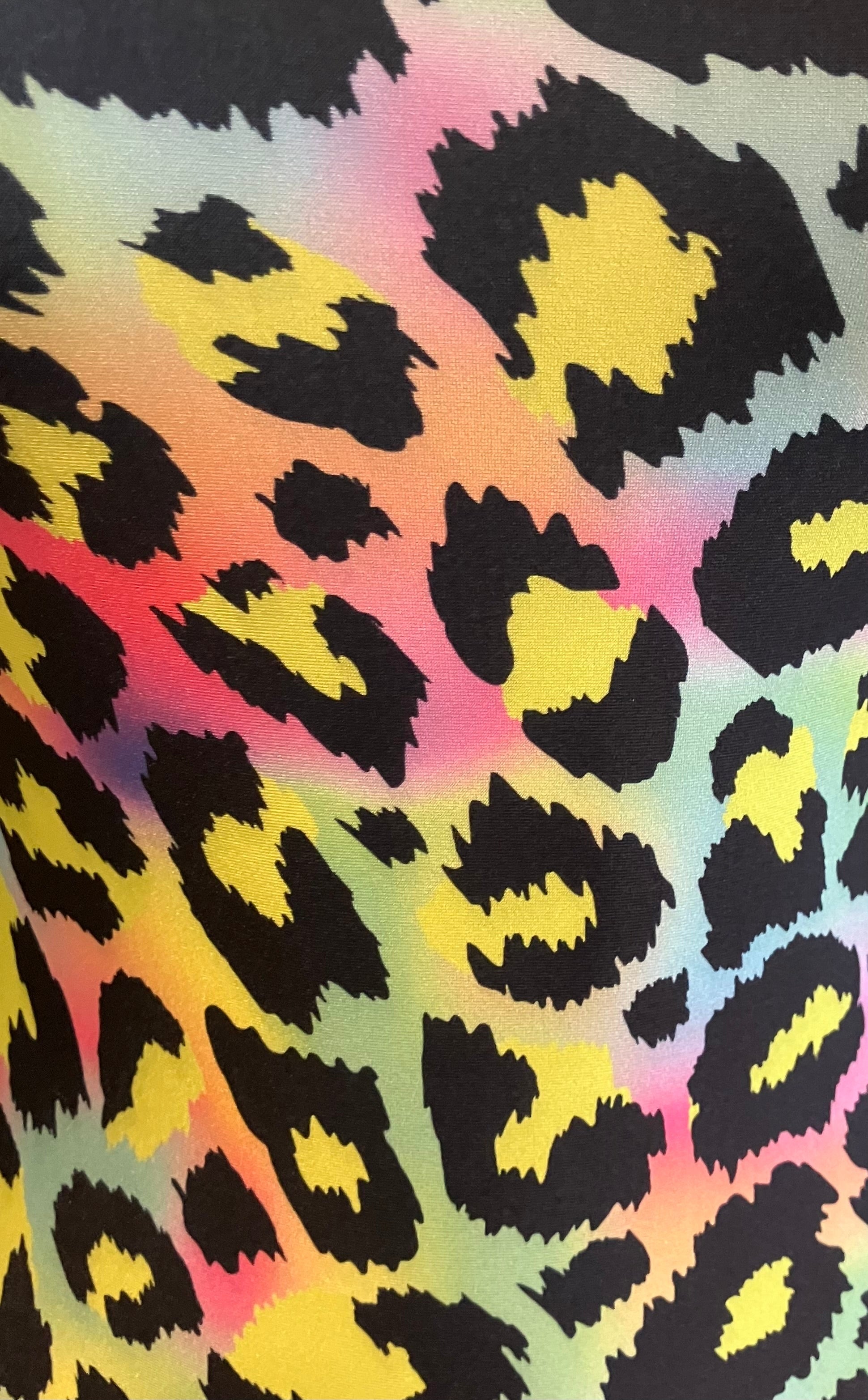Rainbow leopard print fabric with black spots and colorful background.