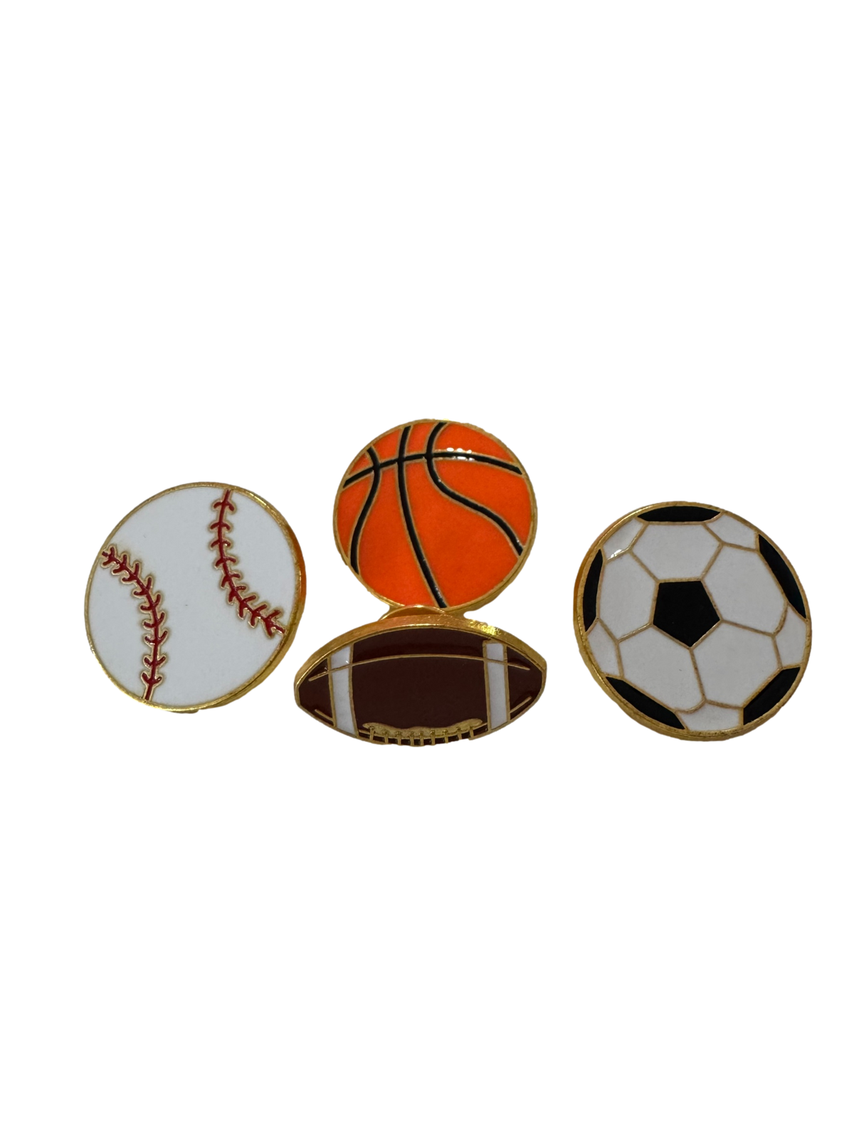 Four sports-themed enamel pins shaped like a baseball, basketball, football, and soccer ball, displayed side-by-side on a plain white background.