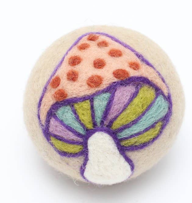 Felted mushroom dryer ball with colorful design on a white background