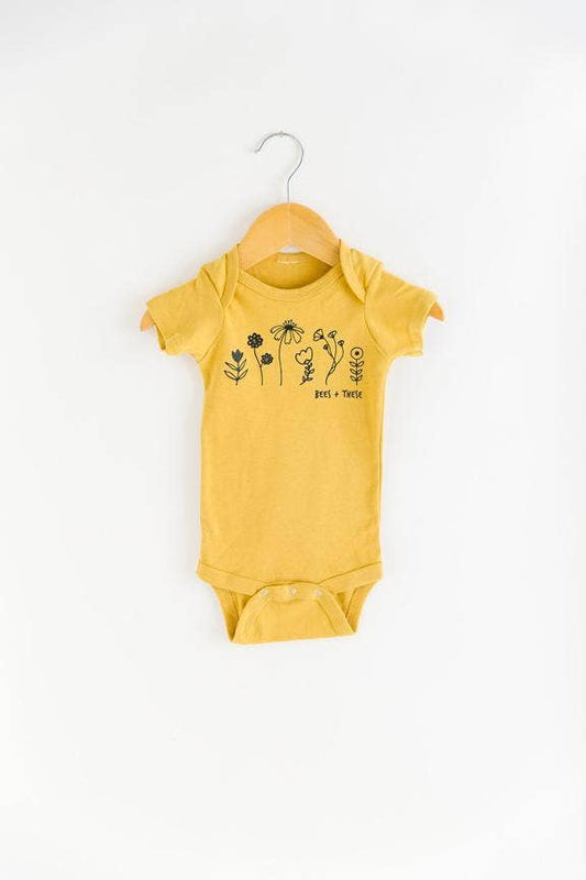 mustard color onesie with flowers