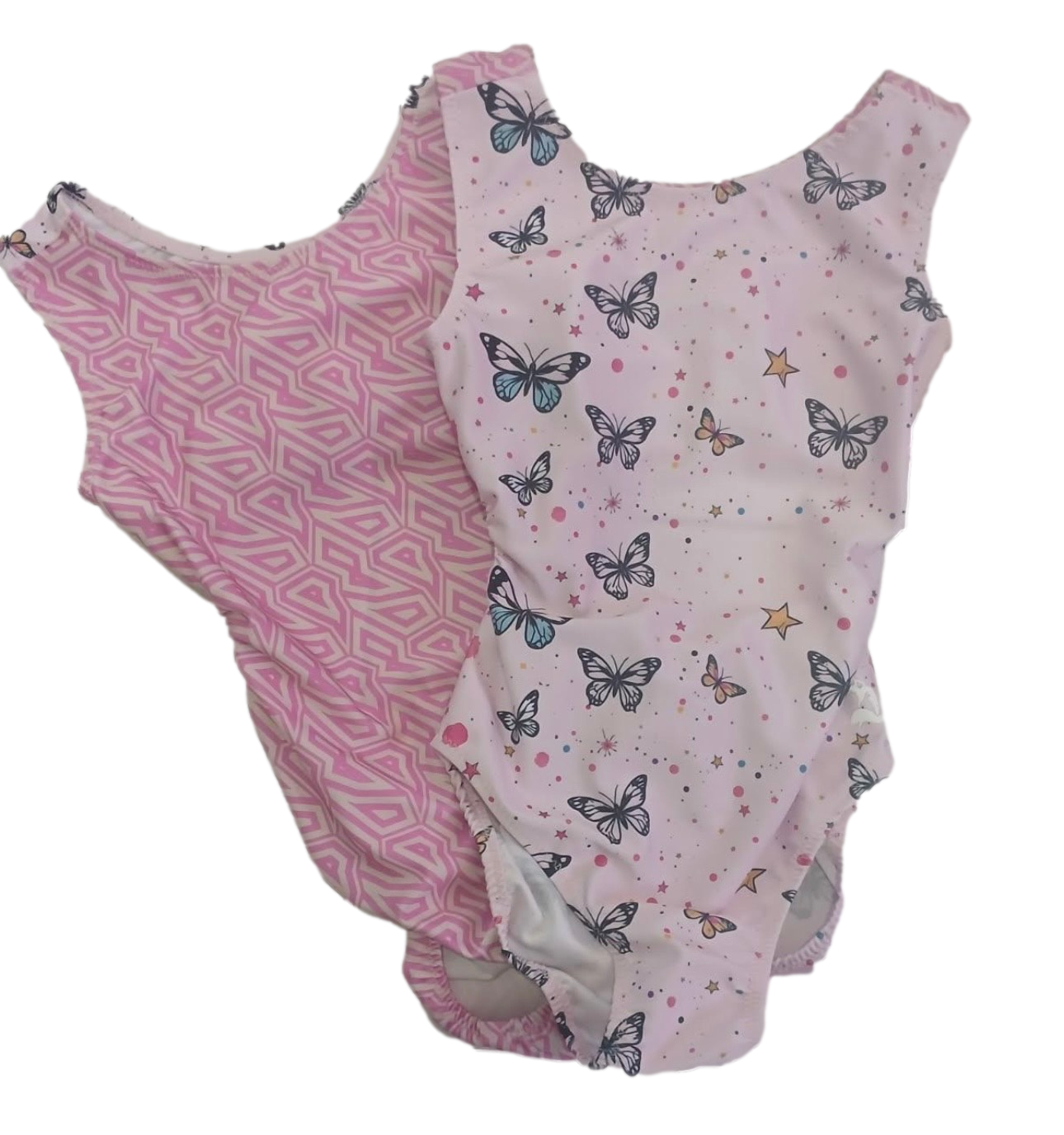 Two children's pink leotards with different patterns on a white background