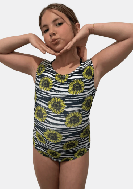 Girl wearing a sunflower-patterned striped leotard against a plain background