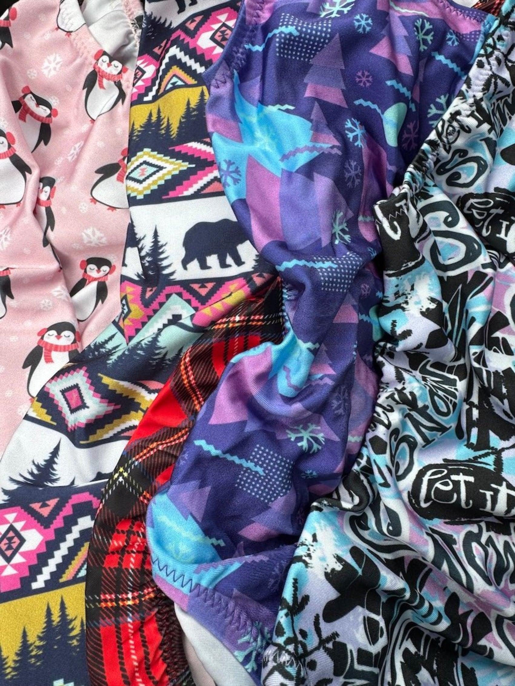 Collection of colorful patterned fabrics with various Christmas designs.