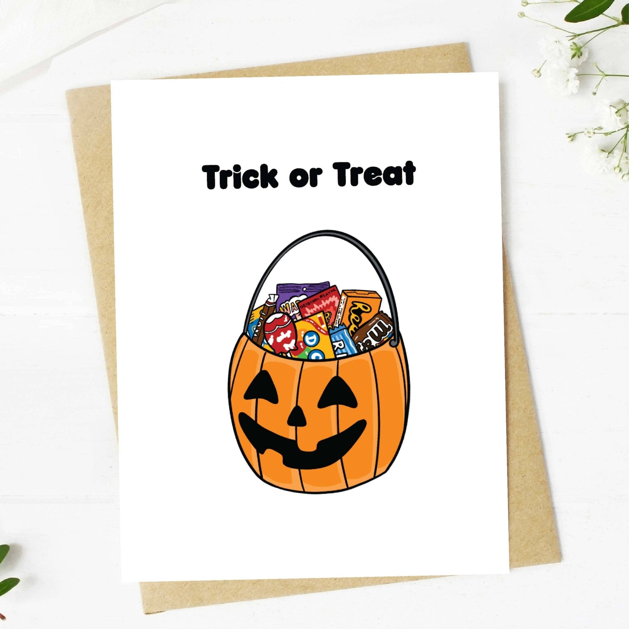 Halloween card with a pumpkin bucket and candy, featuring 'Trick or Treat' text.