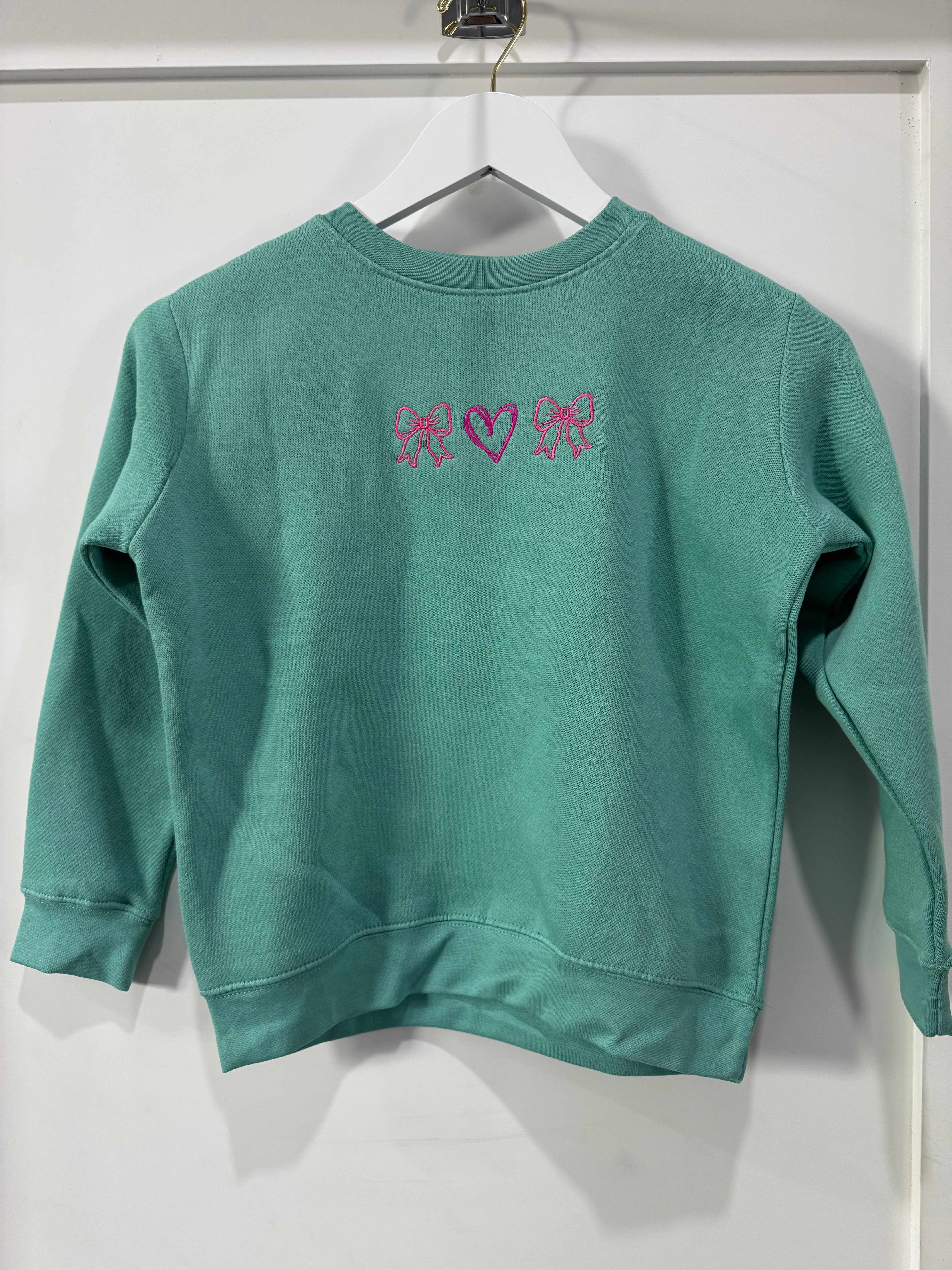 Kids' mint green long-sleeve crewneck sweatshirt with pink embroidered bows and heart