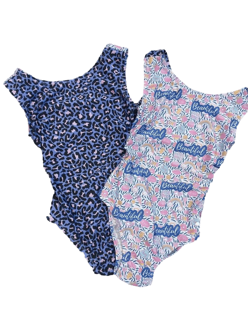 Two gymnastics leotards for girls with different purple animal print patterns on a transparent background