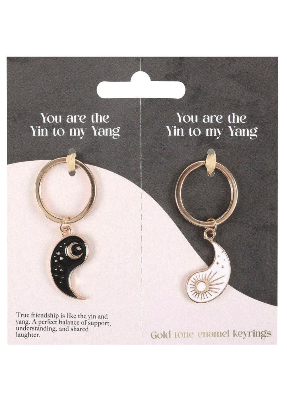Gold-tone enamel keychains with yin and yang symbols on a packaging card.