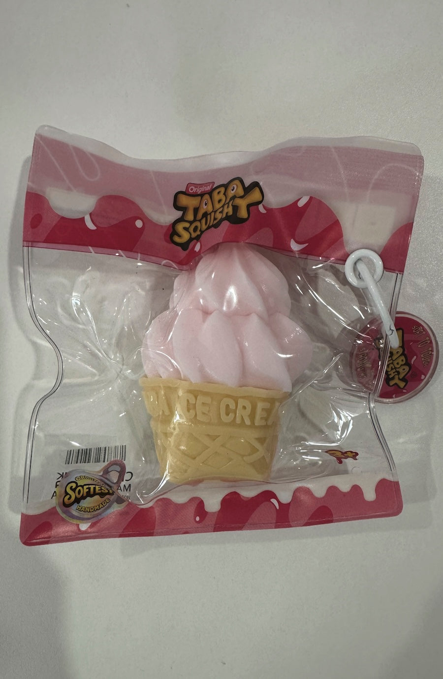 Pink ice cream cone toy with 'Taba Squeeze' branding on a white background