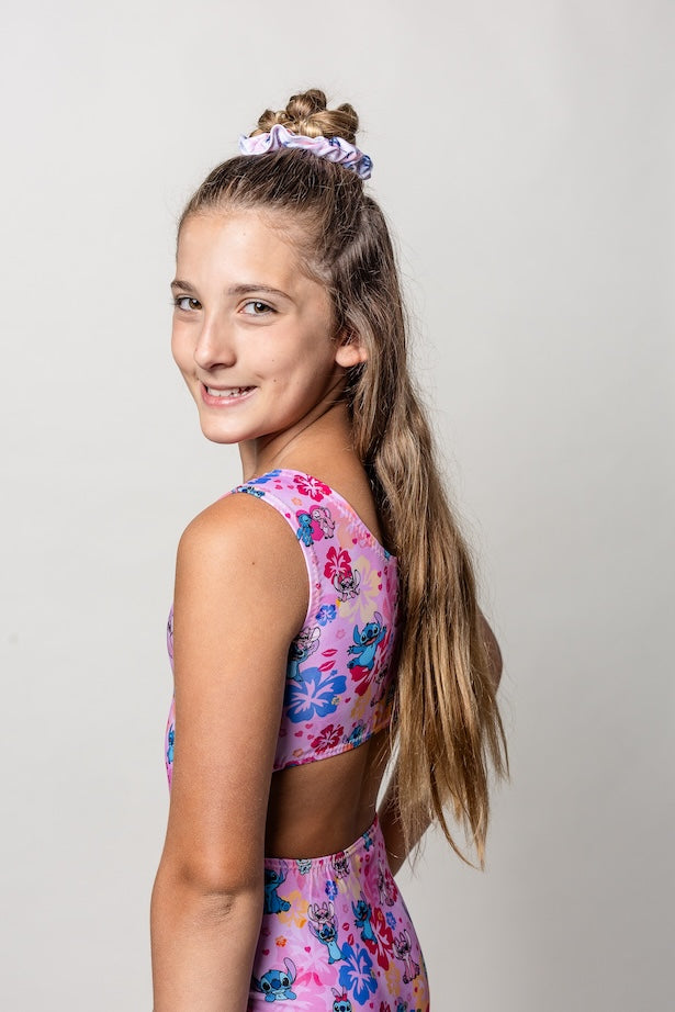 Young girl wearing a pink floral lilo and stitch inspired leotard