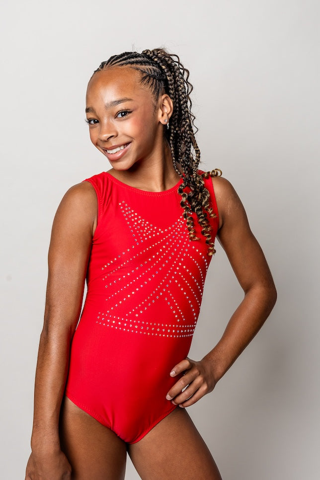 gymnast wearing a red bling leotard with embellishments on a plain background