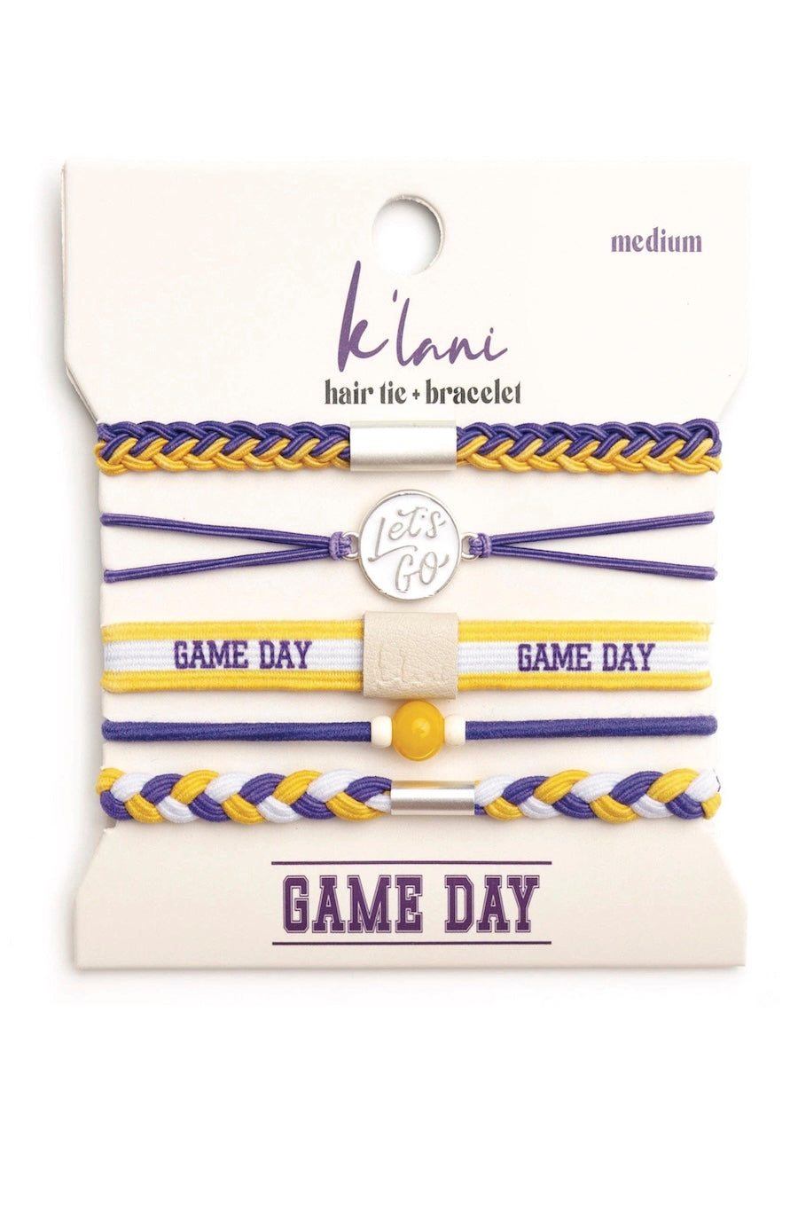A set of five K'lna hair tie bracelets in purple and yellow, displayed on a cream-colored backing card with 'GAME DAY' printed at the bottom.